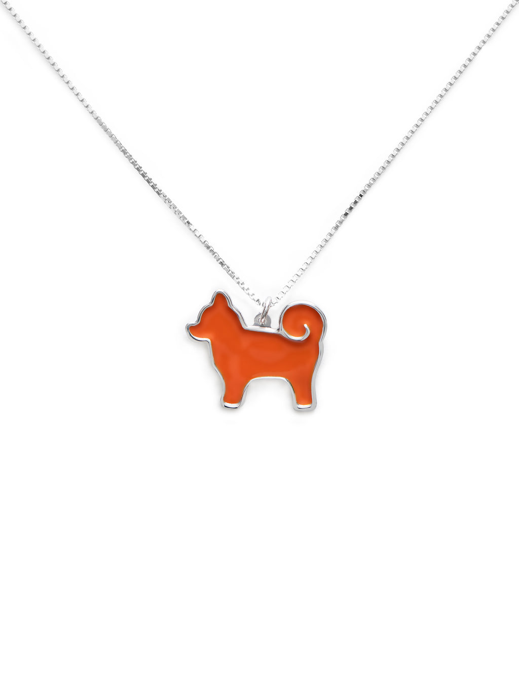 Orange dog-shaped pendant on a silver chain against a white background